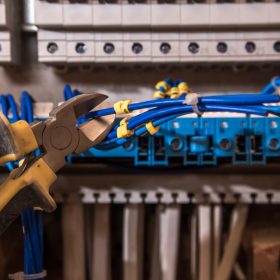 The Assembly Of The Electrical Panel, Electrician Job, A Robot With Wires And Circuit Breakers